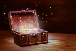 48053504 - beautiful background of mystery chest with light miracle on wooden background with place for text, closeup